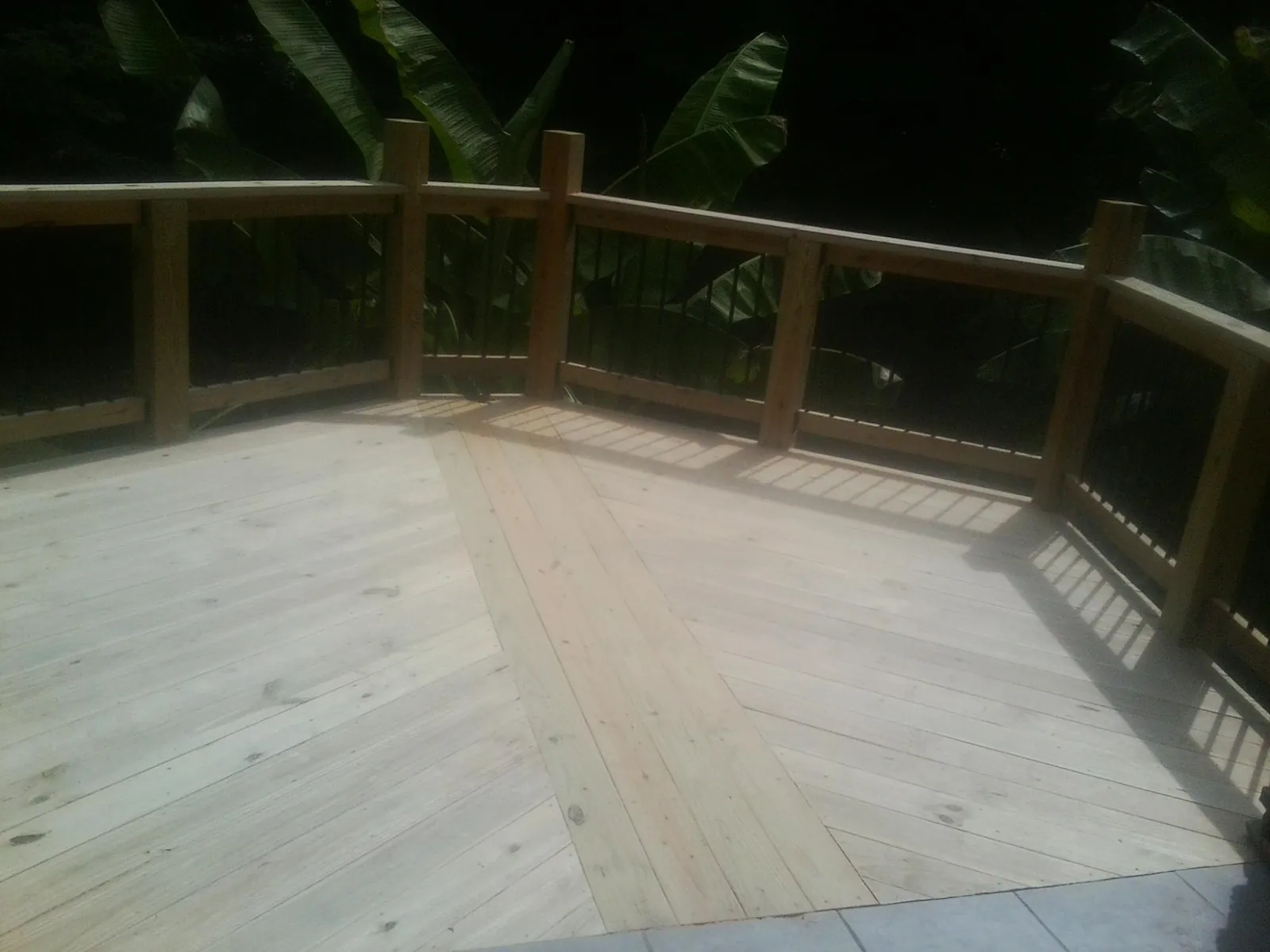 New wood deck and railing built off the back of a home in Schwenksville
