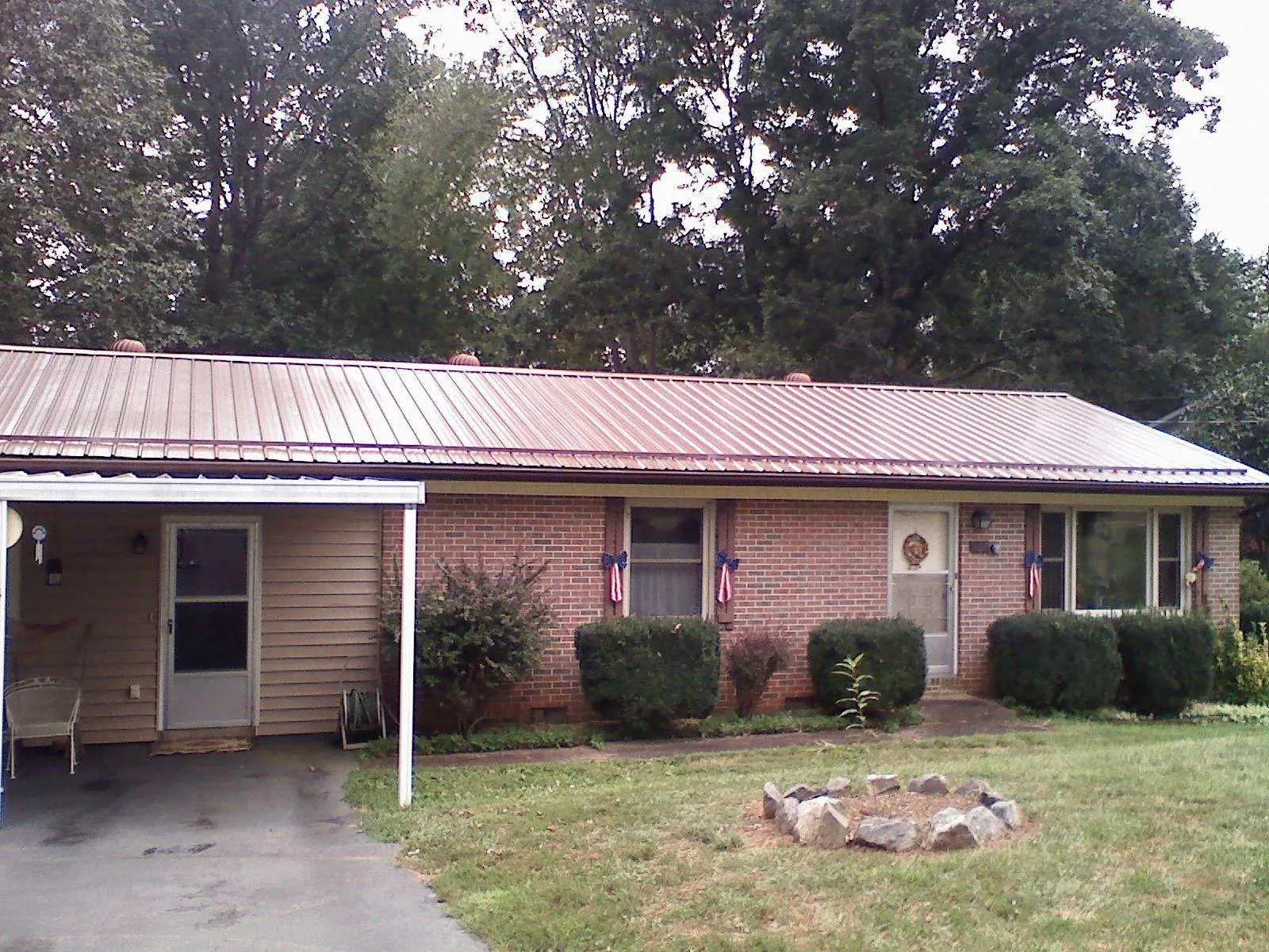 Bronze metal roof and carport on a brick ranch home — Roof Repair work by our crew in Schwenksville